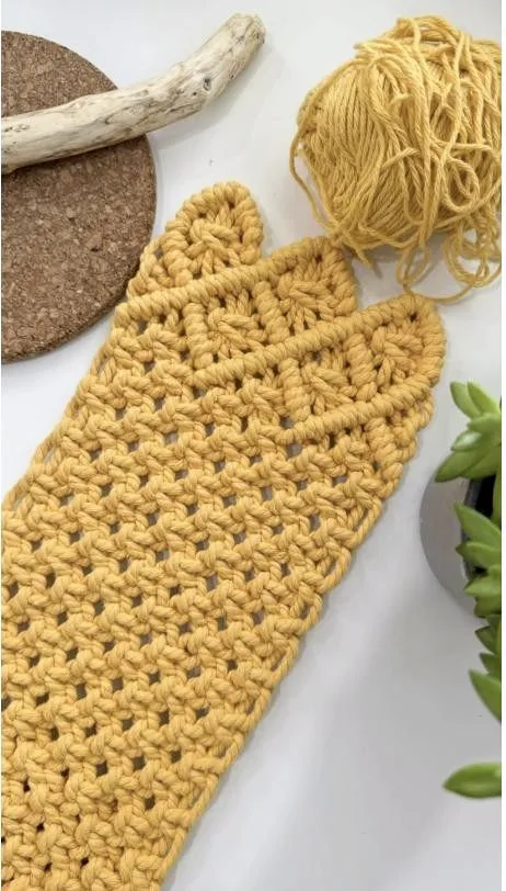 Handmade mustard crochet piece surrounded by cotton yarn in the Bohemia Handmade studio