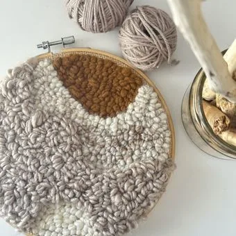 Macrame and weaving hoop in progress with natural cotton fibers