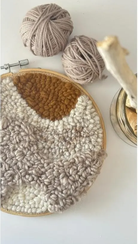 Hand-made fiber wall piece in oat and clay tones, made to hang behind a plaster name